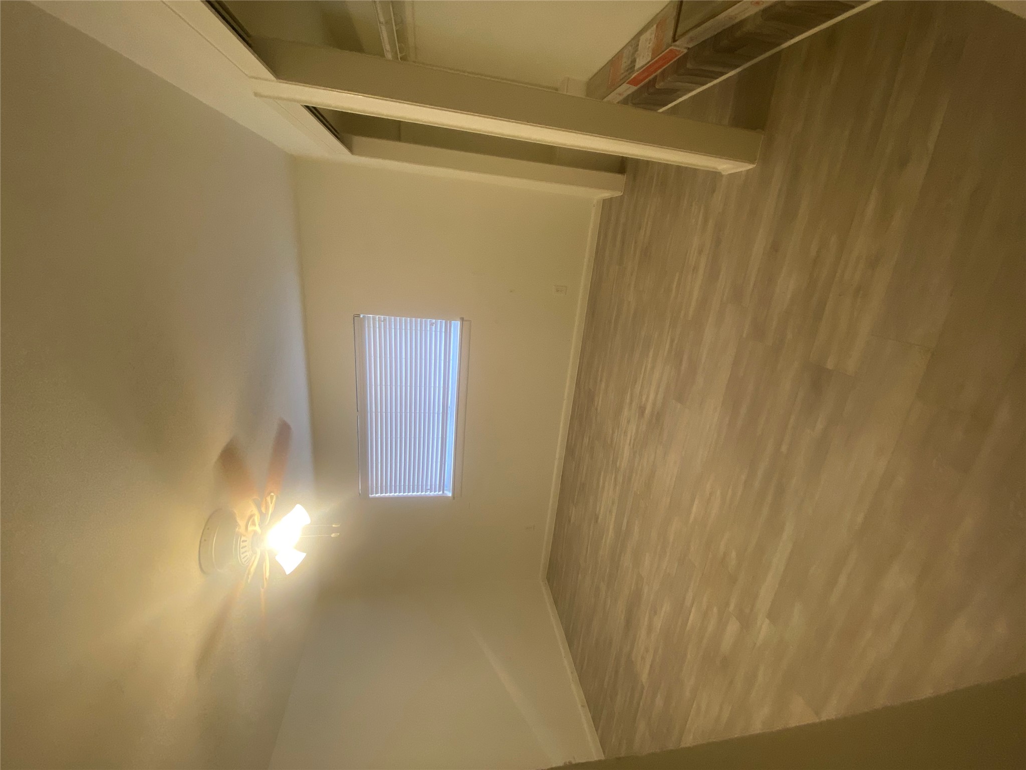 2208 Enfield Road, Unit 10500 Austin, TX 78703 - Photo 6 of 7 Unfurnished bedroom featuring wood finished floors and ceiling fan