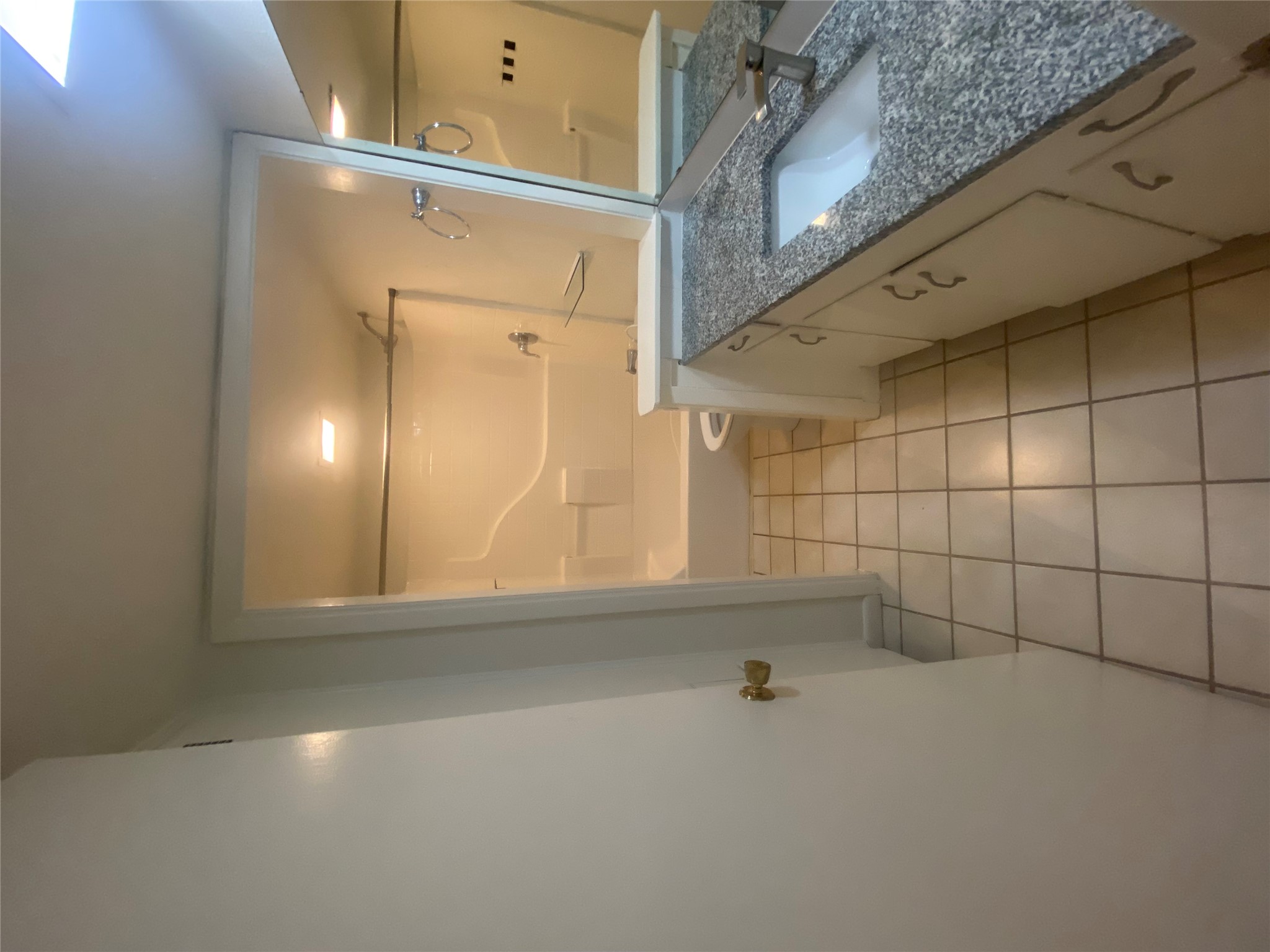 2208 Enfield Road, Unit 10500 Austin, TX 78703 - Photo 7 of 7 Bathroom with vanity, washtub / shower combination, and light tile patterned flooring