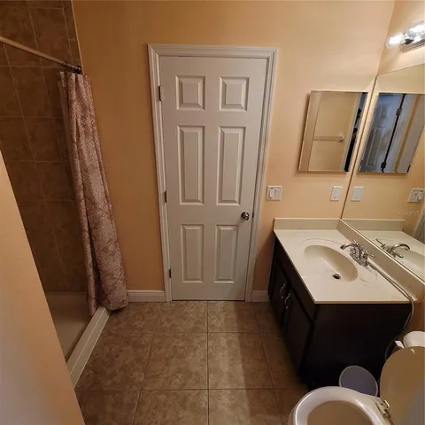 a bathroom with a shower and toilet