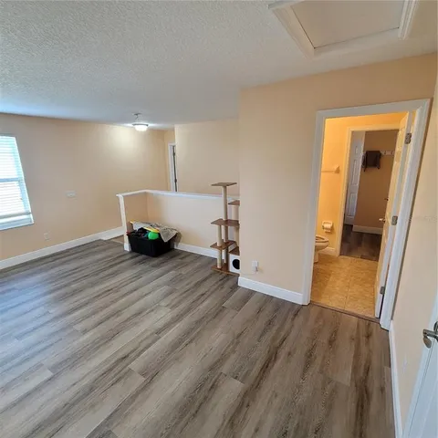 a view of a livingroom with wooden floor and window