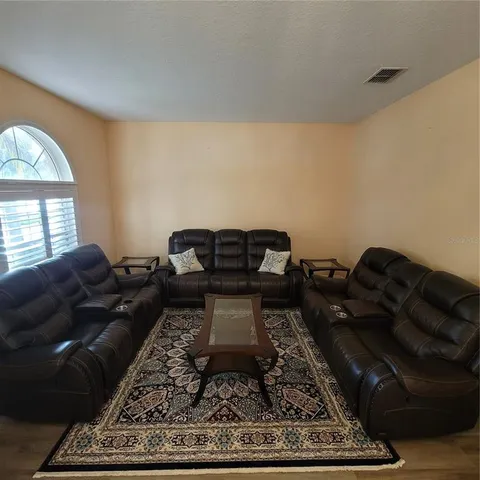 a living room with furniture and a rug