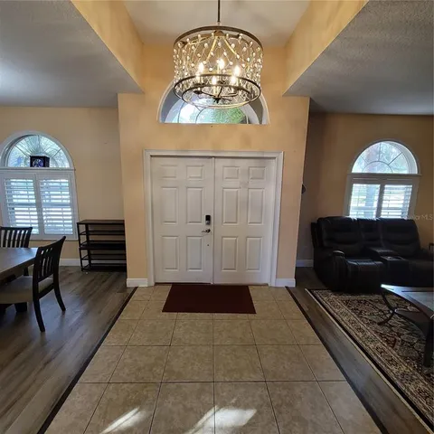 a hallway with cabinets and a window