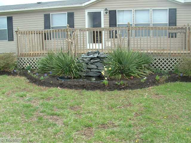 1050 Hill Road King, NC 27021 - Photo 15 of 15 Exterior Front. Close Up of Landscaping and Water Feature by front of home.