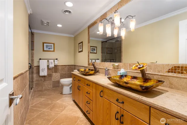 a spacious bathroom with a double vanity sink and a mirror