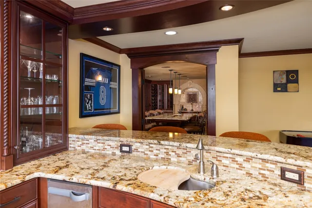 a kitchen with granite countertop sink and cabinets