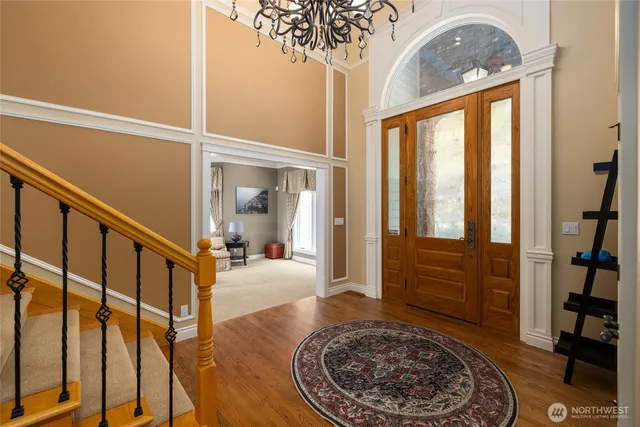 a view of an entryway with wooden floor
