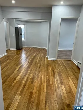 a view of a room with wooden floor
