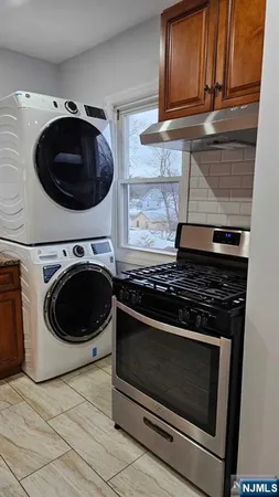 a stove top oven sitting inside of a kitchen