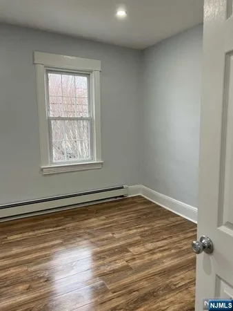 a view of a room with wooden floor and windows