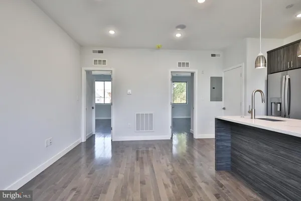 a view of kitchen with sink and wooden floor