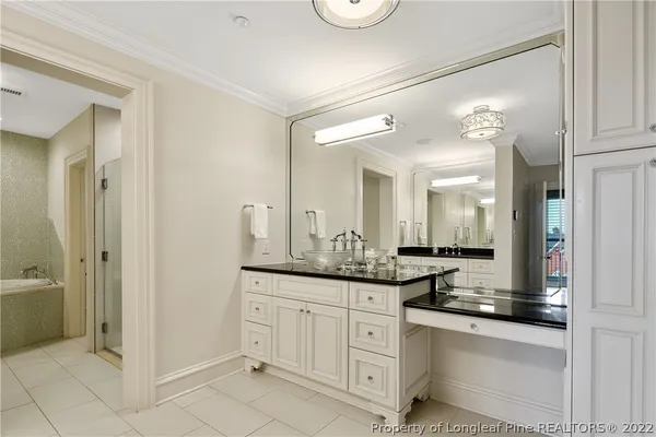 a bathroom with a granite countertop sink a mirror and a shower