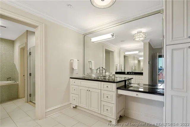 a bathroom with a granite countertop sink a mirror and a shower