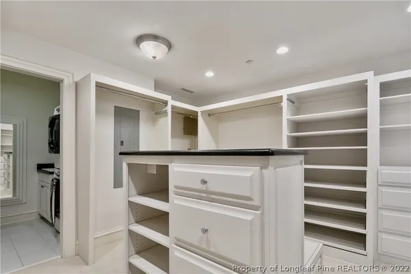 a view of walk in closet with empty racks
