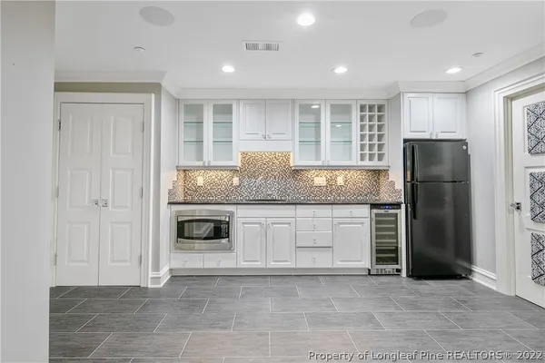 a kitchen with granite countertop a refrigerator and a stove