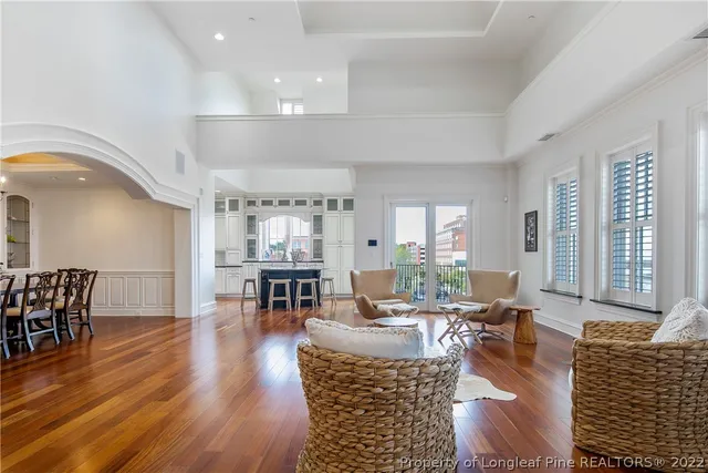 a living room with fireplace furniture and wooden floor