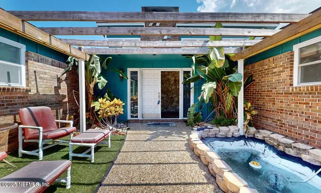 a view of a livingroom with wooden floor and a ceiling fan