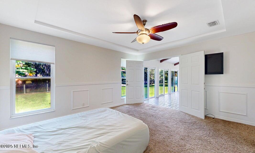 6433 River Point Drive Fleming Island, FL 32003 - Photo 24 of 71 a bedroom with a bed and a view of a livingroom