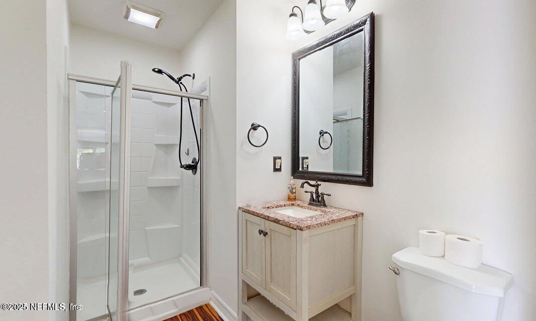 6433 River Point Drive Fleming Island, FL 32003 - Photo 37 of 71 a bathroom with a granite countertop sink mirror and shower