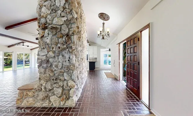 a bedroom with a bed and a view of a livingroom