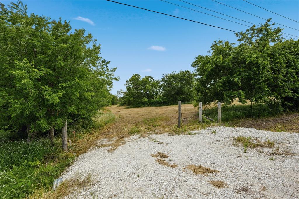 1600 Culpepper Lane China Spring, TX 76633 - Photo 2 of 24 a backyard of a house with large trees and a wooden fence