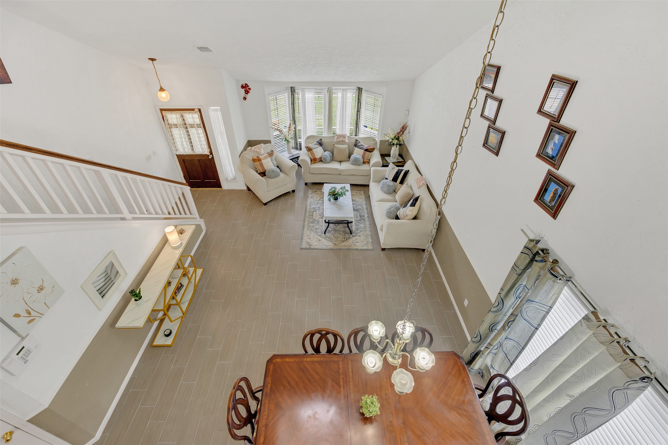 15619 Beechnut Street Houston, TX 77083 - Photo 15 of 29 Stunning view from the second floor showcasing the spacious open-concept living and dining areas below.