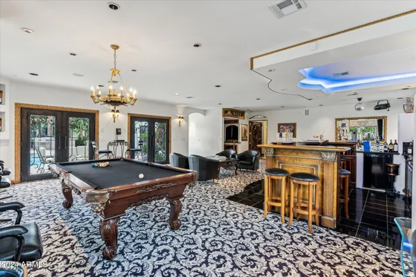 a view of a swimming pool with a yard and plants