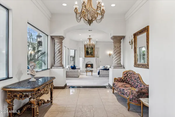 a living room with furniture flower pot and a fireplace