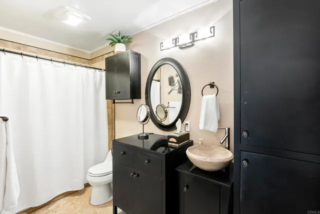 a bathroom with a toilet a sink and a mirror