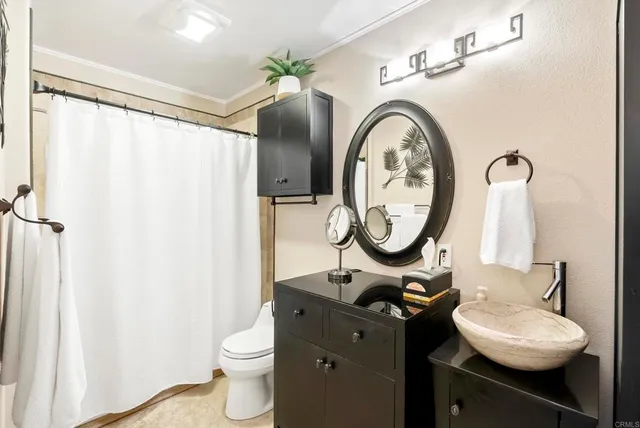 a bathroom with a shower and a sink
