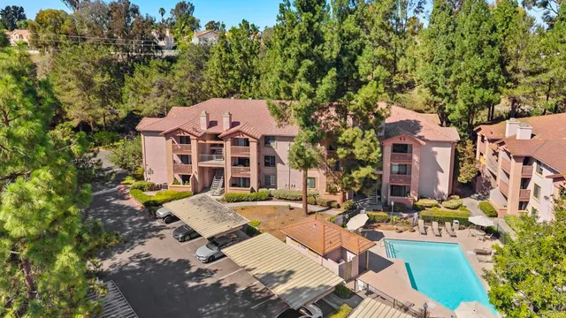 a front view of a residential apartment building with a yard