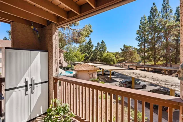 a view of a balcony with wooden floor and fence