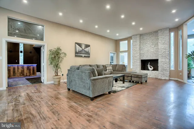 a kitchen with stainless steel appliances granite countertop a kitchen island and chairs in it