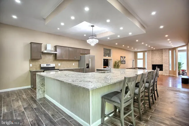 a kitchen with a refrigerator sink and cabinets