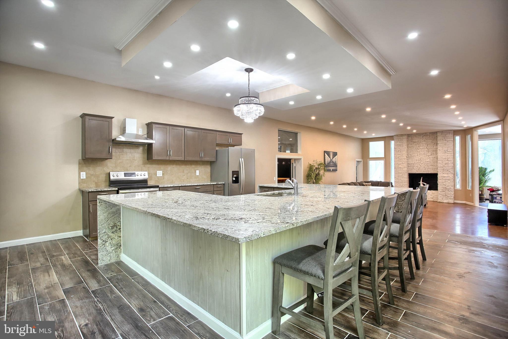 1813 Holly Drive Harrisburg, PA 17110 - Photo 22 of 61 a kitchen with stainless steel appliances granite countertop a kitchen island and chairs in it