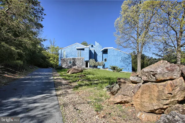 a view of a house with a yard covered with snow in the background