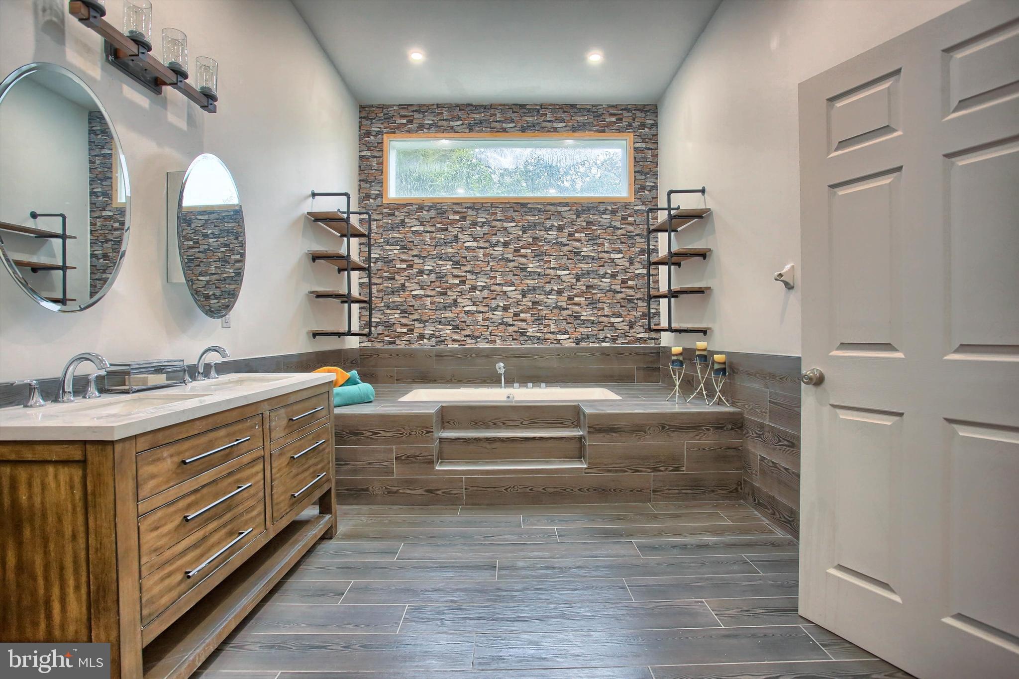 1813 Holly Drive Harrisburg, PA 17110 - Photo 44 of 61 a bathroom with a double vanity sink a mirror and a bathtub
