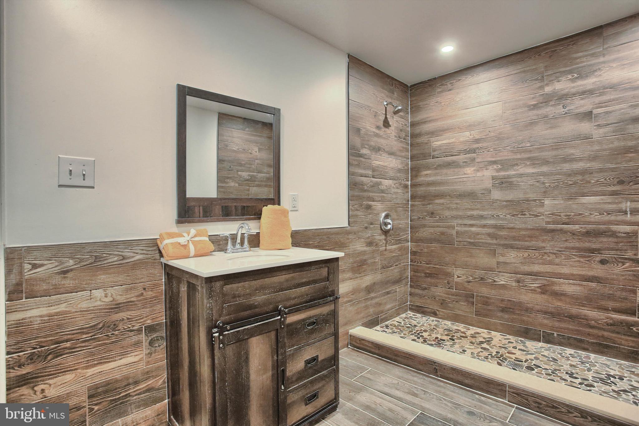 1813 Holly Drive Harrisburg, PA 17110 - Photo 53 of 61 a bathroom with a granite countertop sink a mirror and shower