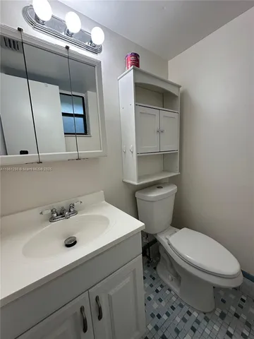 a bathroom with a sink toilet and mirror
