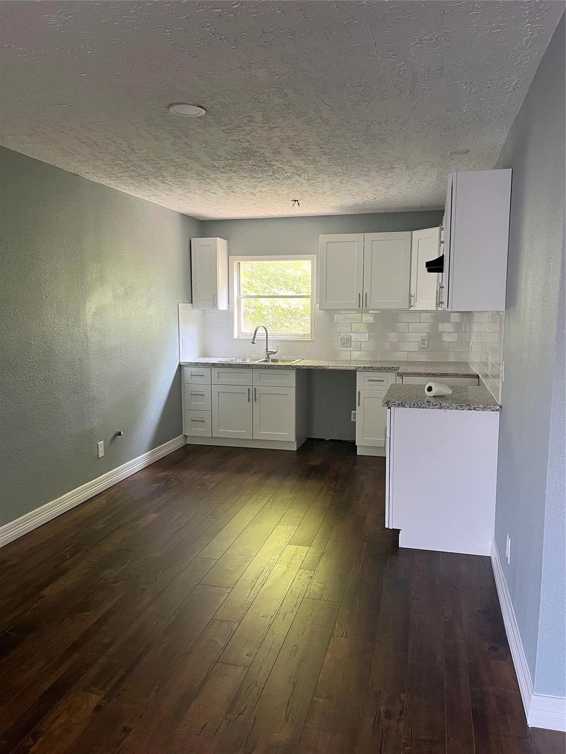 5911 Grace Lane, Unit 3 Houston, TX 77021 - Photo 2 of 7 an empty room with wooden floor and window