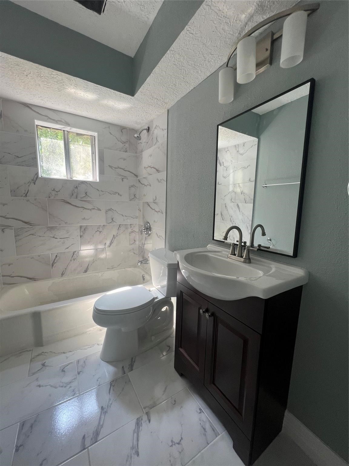 5911 Grace Lane, Unit 3 Houston, TX 77021 - Photo 3 of 7 a bathroom with a toilet a sink and mirror