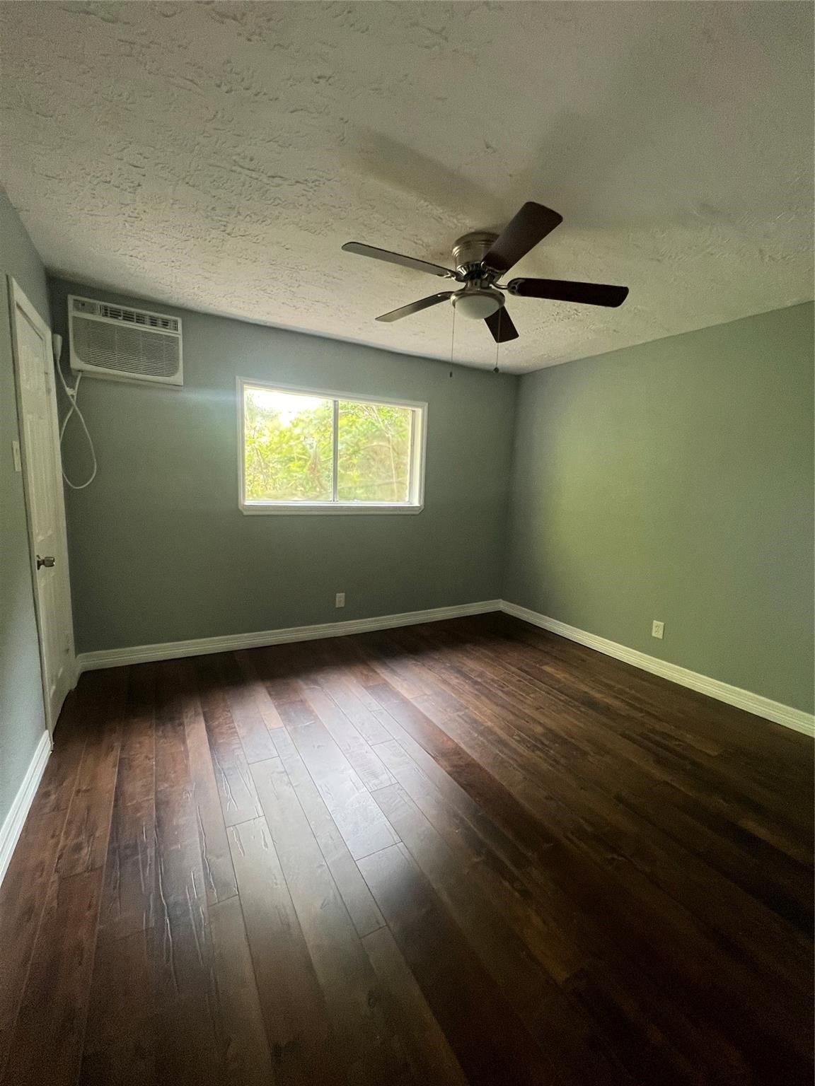 5911 Grace Lane, Unit 3 Houston, TX 77021 - Photo 5 of 7 an empty room with wooden floor and windows