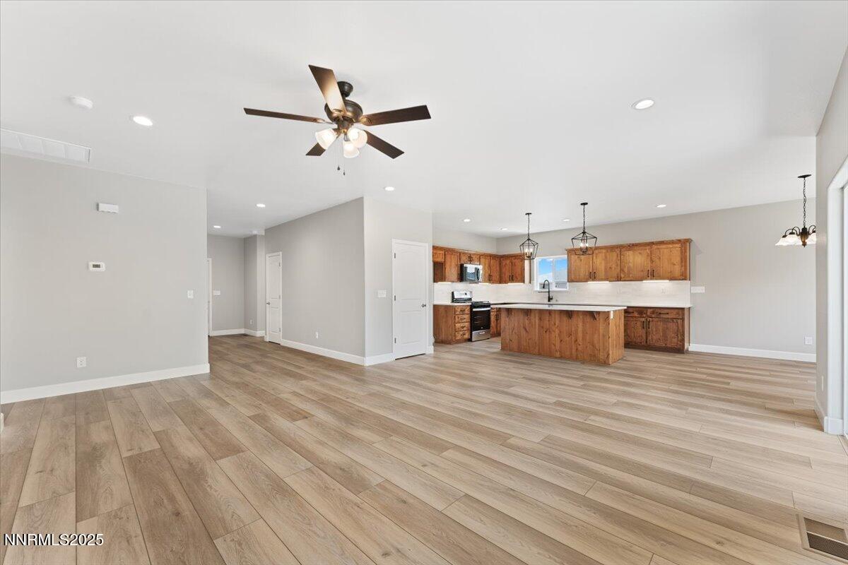 815 Great Basin Lane Fallon, NV 89406 - Photo 14 of 49 a view of a kitchen with wooden floor and cabinet