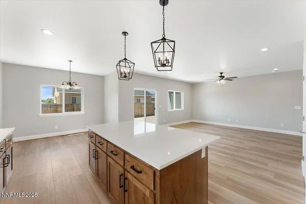 a kitchen that has a microwave a stove and wooden floor