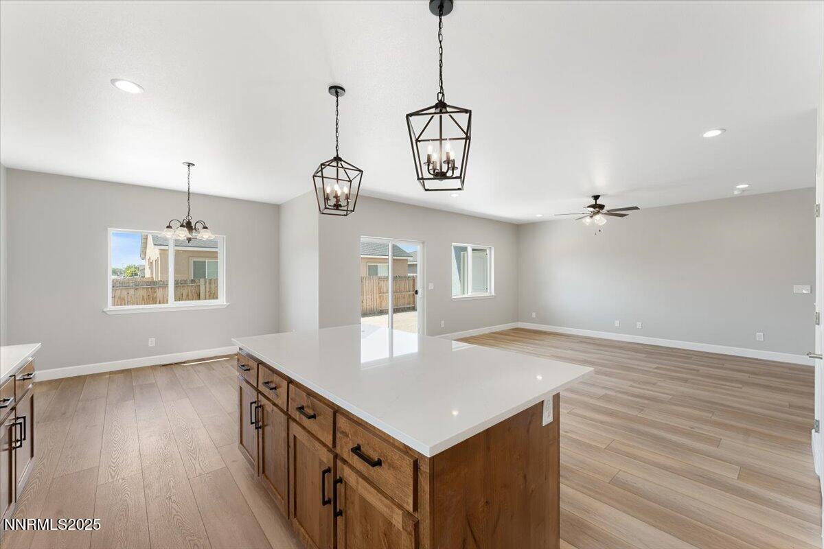 815 Great Basin Lane Fallon, NV 89406 - Photo 21 of 49 a kitchen that has a microwave a stove and wooden floor
