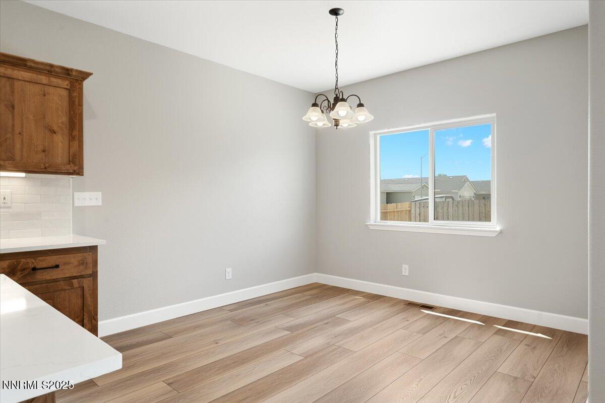 815 Great Basin Lane Fallon, NV 89406 - Photo 24 of 49 a view of empty room with wooden floor and fan