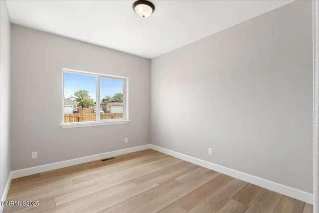 a view of room with wooden floor