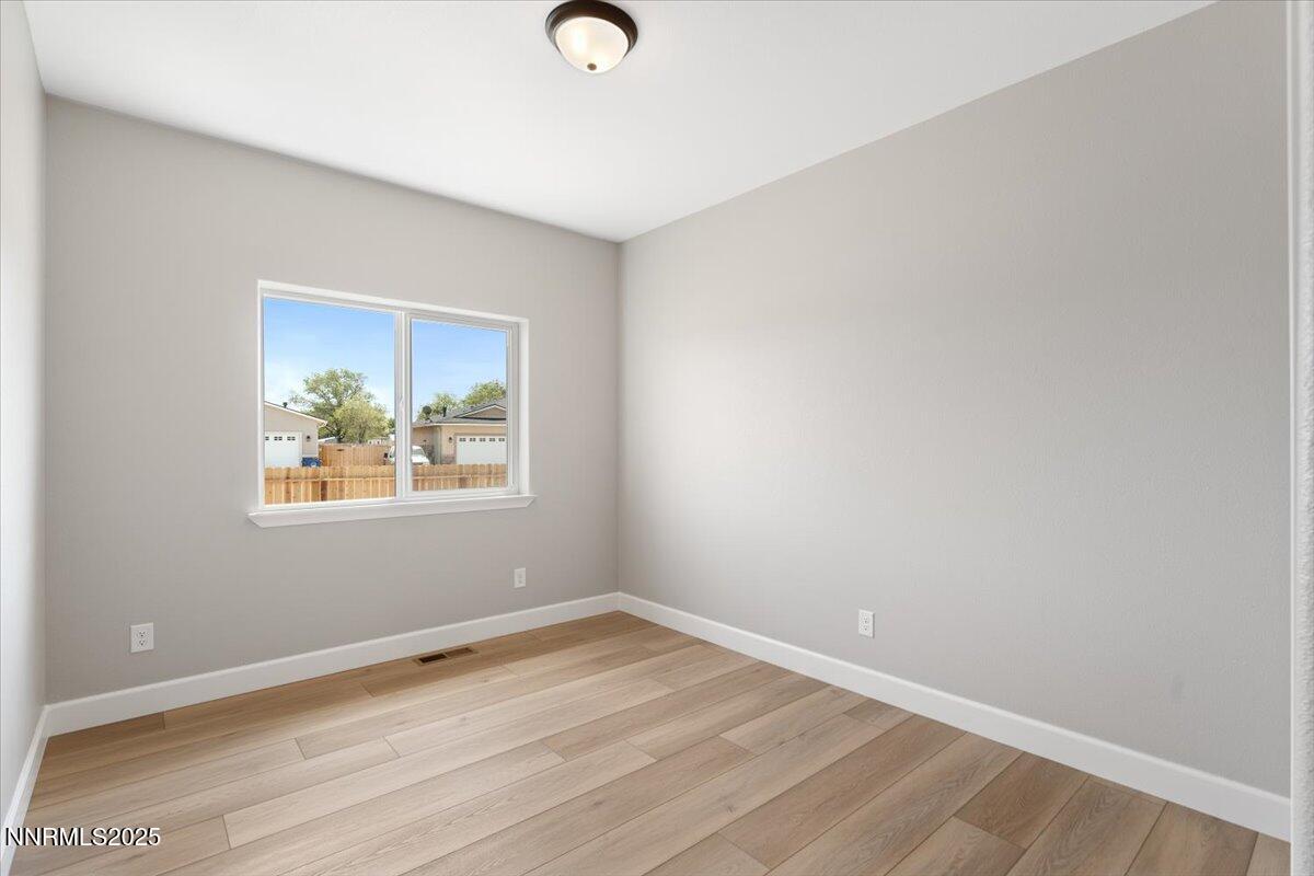 815 Great Basin Lane Fallon, NV 89406 - Photo 34 of 49 an empty room with wooden floor and window