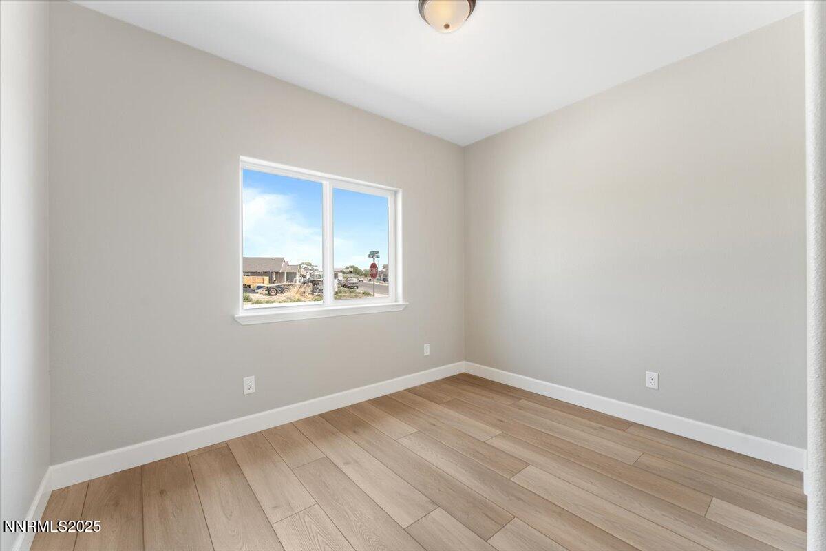 815 Great Basin Lane Fallon, NV 89406 - Photo 38 of 49 an empty room with wooden floor and windows