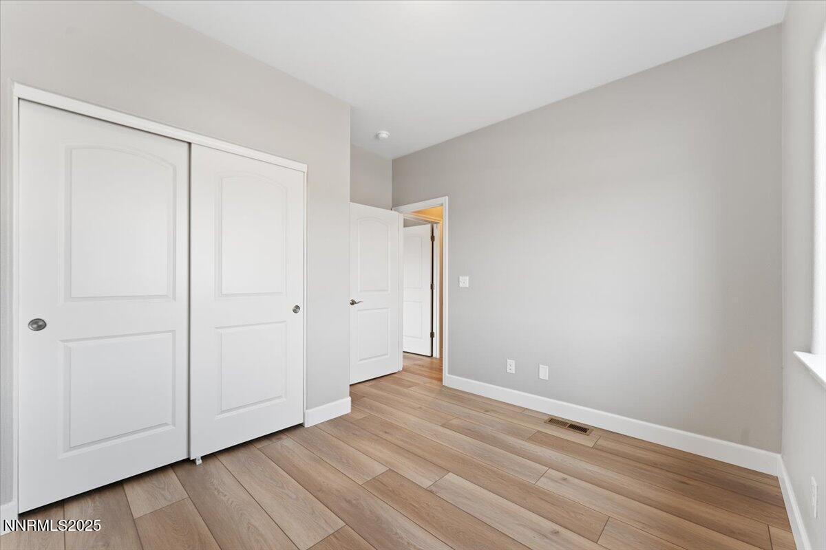 815 Great Basin Lane Fallon, NV 89406 - Photo 39 of 49 a view of an empty room with wooden floor