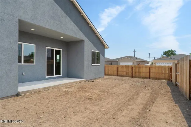 a backyard of a house with wooden fence